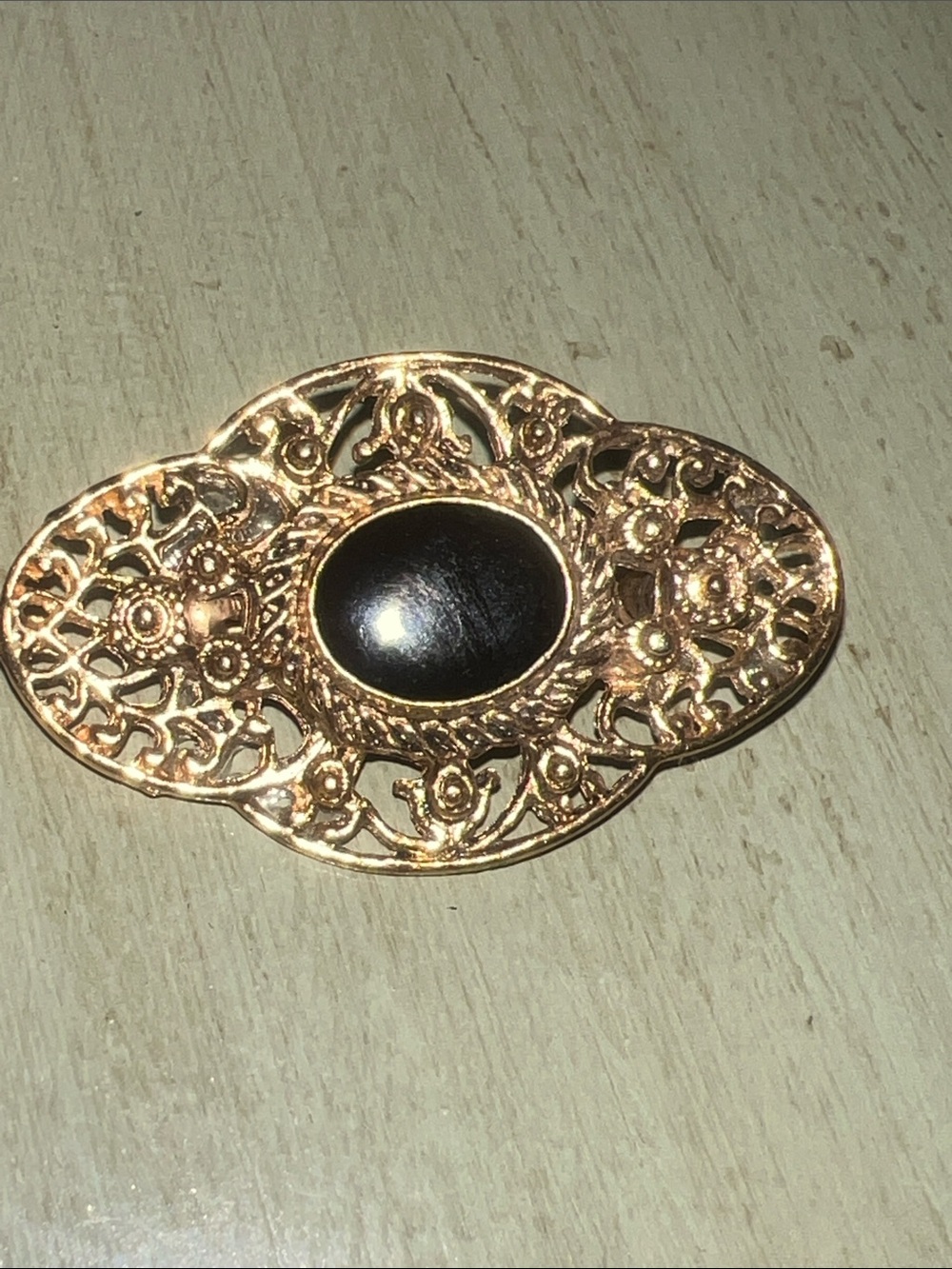 Gold Filigree Oval Brooch with Black Cabochon